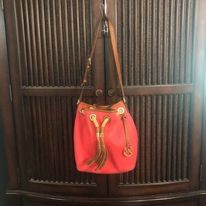 Michael Kors adjustable shoulder strap or cross body tasseled bucket bag.